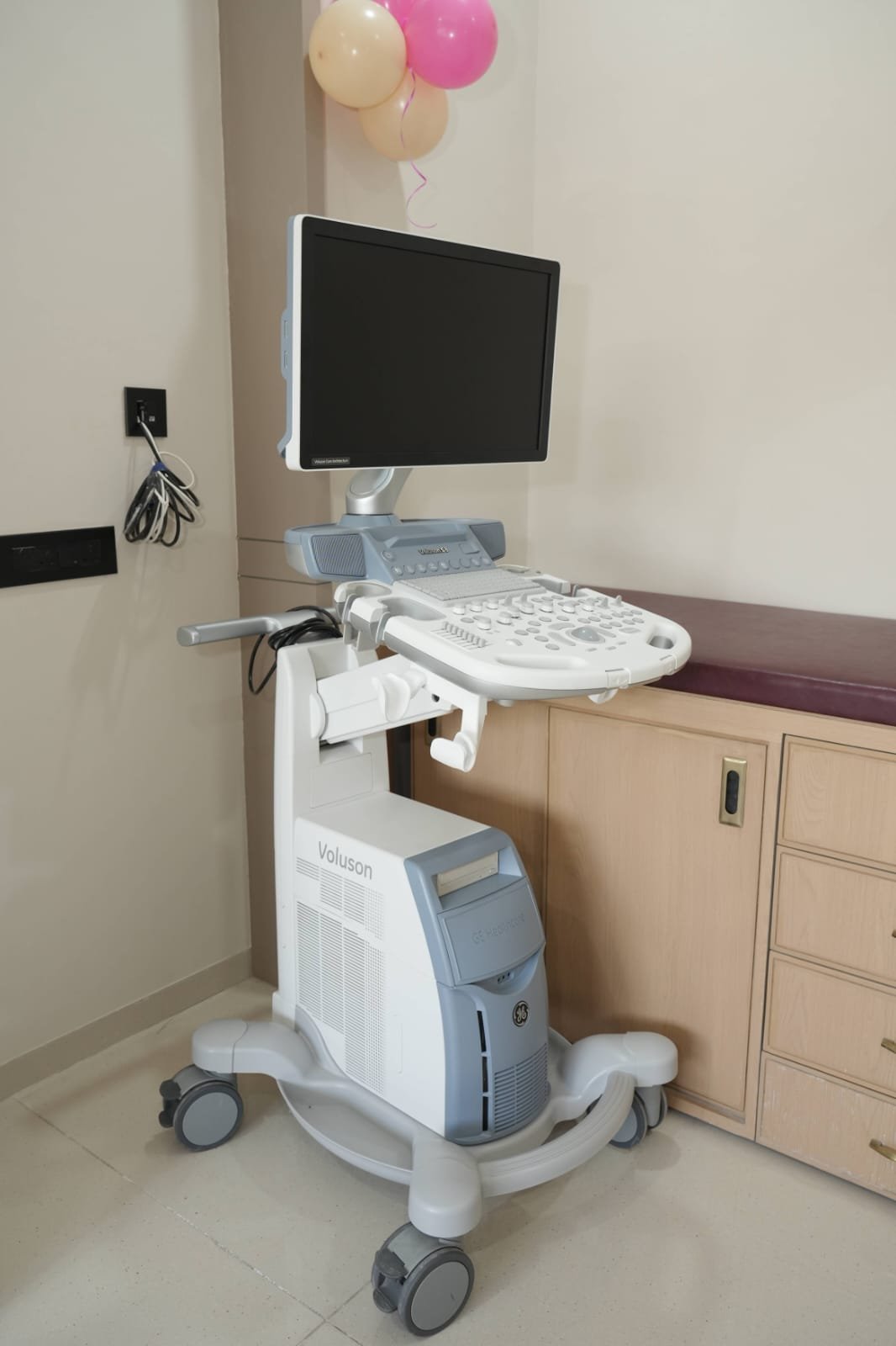 Healthcare professional beside ultrasound equipment in a clinical setting